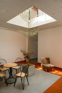 a room with a table and chairs and a tree at Benny Homestay Huế in Hue