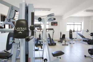 a gym with a lot of treadmills and machines at Lavras Apart Hotel in Lavras