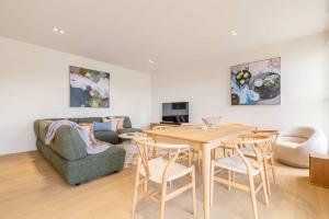 a living room with a table and chairs and a couch at Stylish Spacious Apartment in Malvern in Melbourne