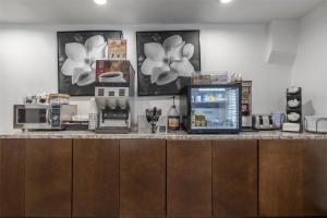 a kitchen with a counter with a coffee maker and appliances at SureStay Hotel by Best Western Beverly Hills West LA in Los Angeles