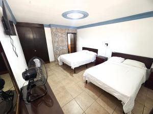 a hotel room with two beds and a camera at Hotel paseo de la montaña in Silao