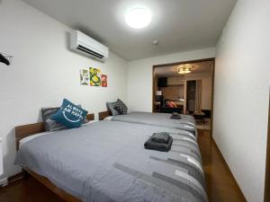 Ένα ή περισσότερα κρεβάτια σε δωμάτιο στο クラージュ本郷通