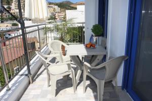 a balcony with a table and chairs on a balcony at SunOrama Apts-Studios in Bali