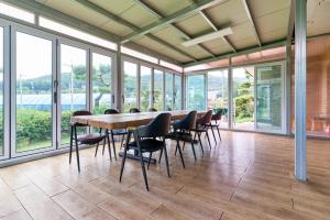 a conference room with a long table and chairs at Daebudo Nonddureong in Ansan