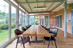 a large wooden table in a room with chairs at Daebudo Nonddureong in Ansan