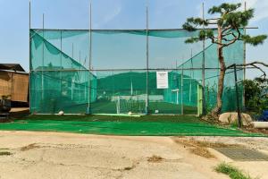 a tennis court in front of a fence at Daebudo Nonddureong in Ansan +4 photos