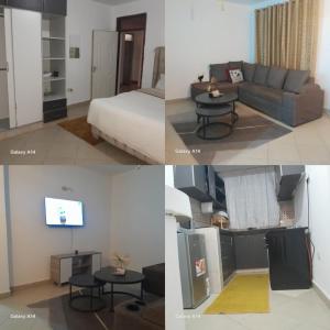 a room with a bed a couch and a tv at Elyon homes in Kitengela 