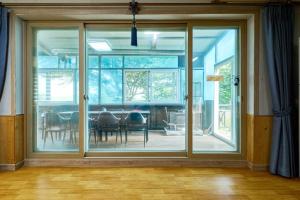 a dining room with a large sliding glass door at Daebudo Batddureong in Ansan