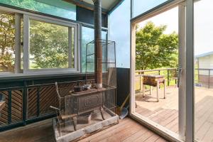 an open door to a porch with a bird cage at Daebudo Batddureong in Ansan +7 photos