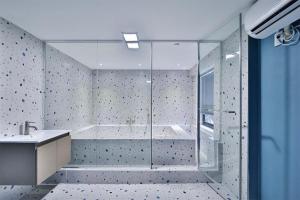 a bathroom with a shower and a tub and a sink at Namunuelbo Hotel Uhbang Branch in Sambang-dong +15 photos