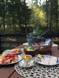 a table with plates of food and fruit on it at Chata pod lesem in Rýmařov