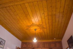 a room with a ceiling fan and a wooden ceiling at Old Bazaar 1790 in Gjirokastër