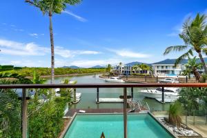 a view from the balcony of a house with a swimming pool at Belle Escapes Marina Quay in Yorkeys Knob