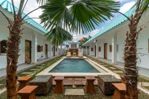 an external view of a villa with a swimming pool at The Lotus Backyard Uluwatu in Badung