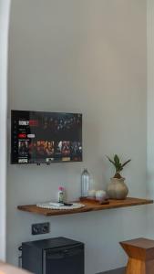a wall with a shelf on a white wall at The Lotus Backyard Uluwatu in Badung