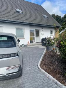 a white car parked in front of a house at Baltic view in Heiligenhafen