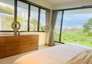 a bedroom with a bed and a large window at Paradise in Lembongan awaits in Nusa Lembongan +35 photos