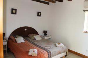 a bedroom with a bed with two pillows on it at Gite du Perche in Saint-Ouen-de-Sècherouvre
