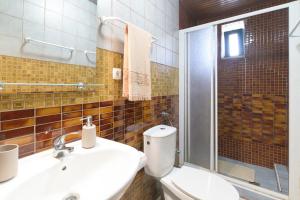 a bathroom with a toilet and a sink and a shower at Costa Vicentina in Cercal +21 photos