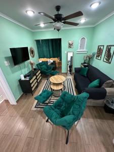 a living room with a couch and a table at Gorgeous 1 Bedroom Gem at Negril 7Miles Beach Point Village 