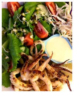 a plate of food with lettuce and a salad at Tri M Waves Lodge in Ponta do Ouro