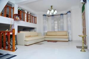 a living room with a couch and a fireplace at Malaka Inn Bandarawela in Bandarawela