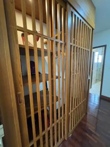 a wooden cell with bars on a room at Mango Tree Resort in Chiang Mai