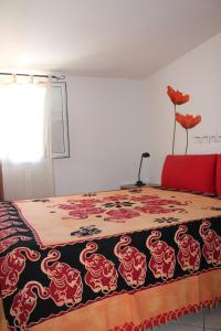a bedroom with a bed with a dragon blanket at Mansarda 25 in Terracina