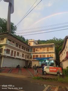 a group of buildings on a street with a truck at Josco Residency Karthikapuram in Paithalmala +7 photos