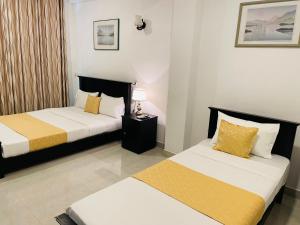 a hotel room with two beds in a room at 4 Axes Ella in Ella +21 photos