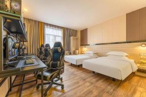 a hotel room with two beds and a desk at Wenxing Hotel Dongguan Qifeng Branch in Dongguan +242 photos