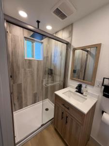 a bathroom with a shower and a sink at Mountain Home 4 Family and Friends in Captain Cook