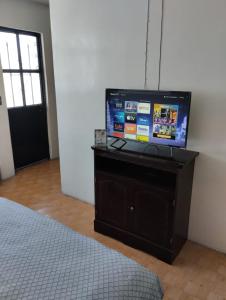 a flat screen tv sitting on a dresser in a bedroom at Hotelito Ejido de la 10 in Puebla