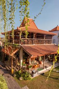 a house with a red roof at Puri Kaja House in Badung