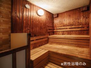an empty sauna with wooden walls and wooden floors at Hamilton Hotel Blue in Nagoya