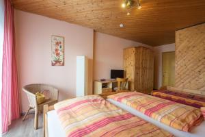 a bedroom with a large bed with a wooden ceiling at Hotel Haus Gertrud in Simmerath