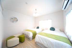 Postel nebo postele na pokoji v ubytování Miraie Kuwana Shimofukayabe 2