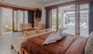 a large bedroom with a large bed and a living room at Villa Dunia Lembongan in Nusa Lembongan +43 photos