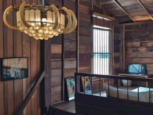a chandelier is hanging in a room with wooden walls at Suneta Hostel Chiangkhan in Chiang Khan