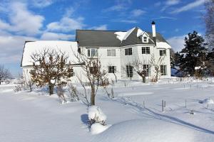 a white house in the snow with trees in front at Asahikawa - House - Vacation STAY 78092v in Asahikawa
