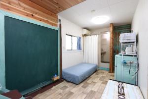 a classroom with a green chalkboard in a room at あさひシーサイドコテージ in Asahi