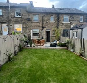 a garden in front of a house at Olive Tree Cottage in Golcar +5 photos