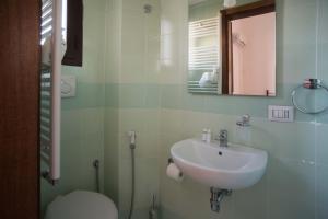 a bathroom with a sink and a toilet at ABACA Rooms in Lecce