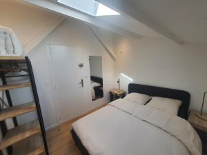 a bedroom with a white bed and a ladder at Quiet house for 6 people with parking - 5 minutes from Timone University Hospital in Marseille