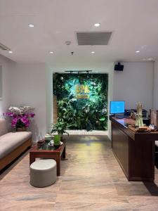 an office with a large mural of plants on the wall at Grands StarCity in Nha Trang