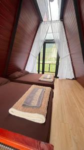 Postel nebo postele na pokoji v ubytování Dieng Ceria Resort + 13 fotografií