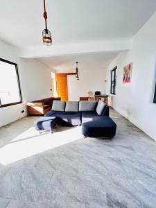 a living room with a couch and a table at Luxurious 3 Bedroom Villa with Private Pool - NG1 in Arsenal