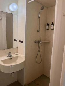 łazienka z prysznicem i umywalką w obiekcie Jinjiang Inn Hotel Tianjin Xinkai Road Branch w mieście Tiencin