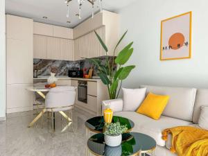 a living room with a couch and a table at Qoople Legend B - premium apartments steps from the sea in Alanya