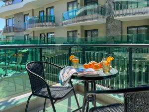 a table with oranges on top of a balcony at Qoople Legend B - premium apartments steps from the sea in Alanya +34 photos